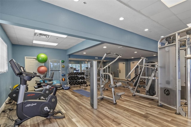 workout area featuring hardwood / wood-style flooring and a paneled ceiling