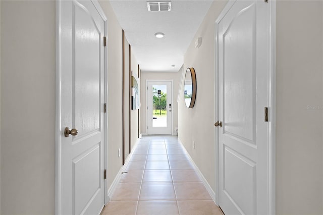 corridor featuring light tile patterned flooring