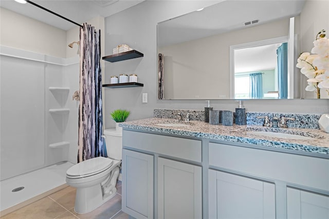 bathroom with tile patterned floors, vanity, curtained shower, and toilet