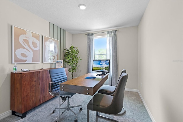 carpeted office with a textured ceiling