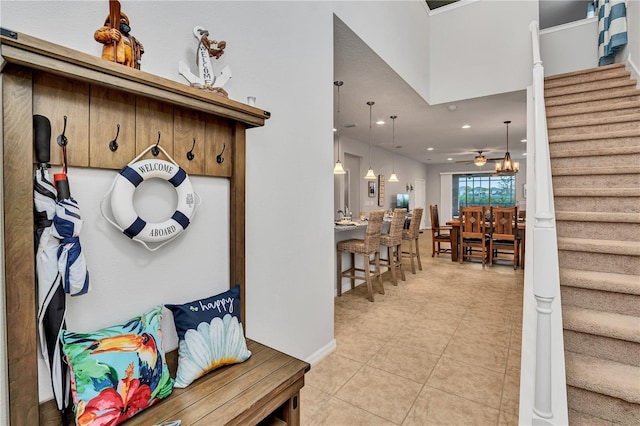 mudroom featuring ceiling fan and light tile patterned flooring