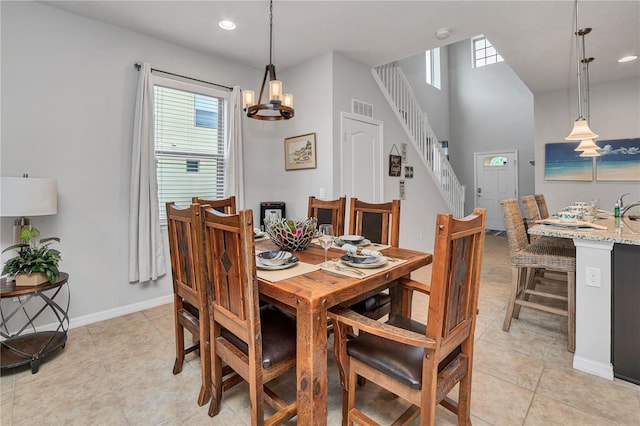 tiled dining room with a notable chandelier