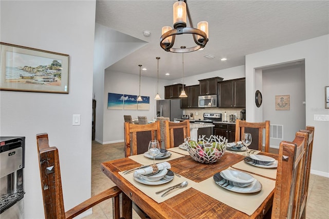 dining area featuring light tile patterned flooring and a chandelier