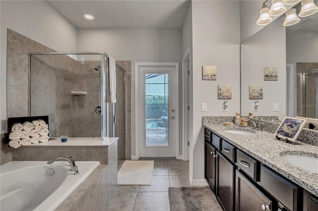 bathroom with tile patterned flooring, vanity, and plus walk in shower