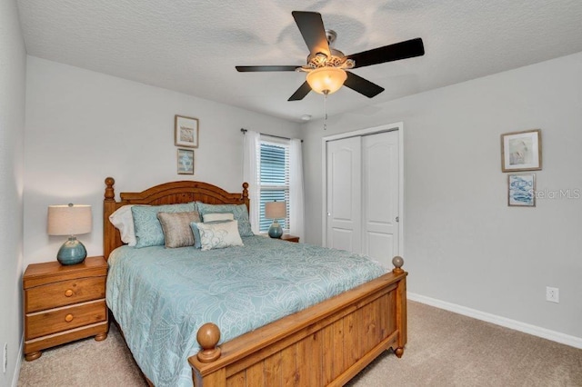 carpeted bedroom featuring ceiling fan and a closet