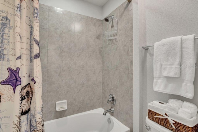 bathroom with toilet and shower / tub combo with curtain