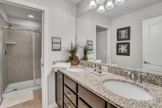 bathroom with tile patterned flooring, vanity, and an enclosed shower