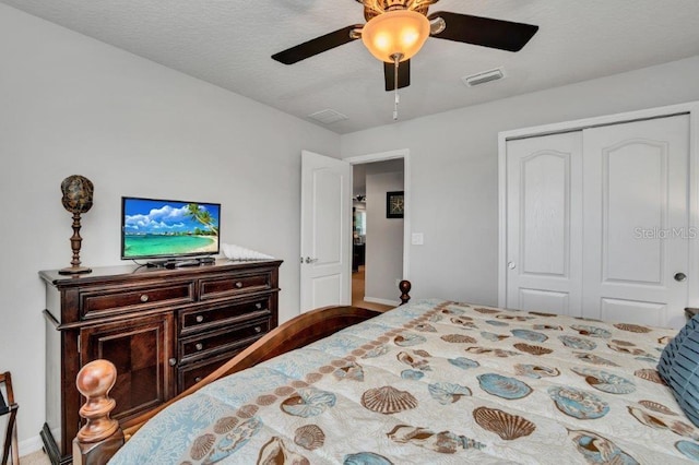 bedroom with ceiling fan and a closet