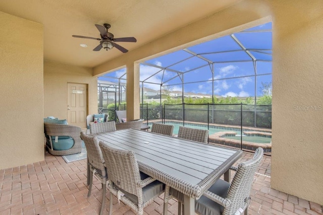 view of patio / terrace featuring ceiling fan and a lanai