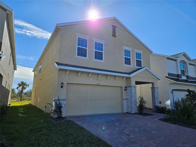 view of front of house with a garage and a front lawn