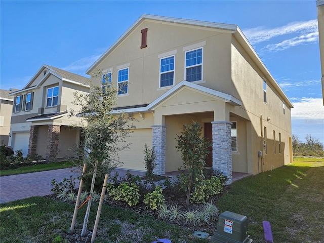 view of front of house featuring a garage and a front lawn