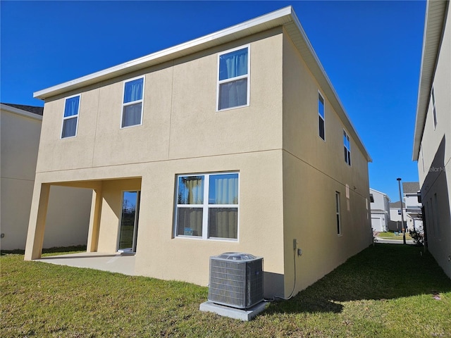 rear view of house with a yard, central AC, and a patio