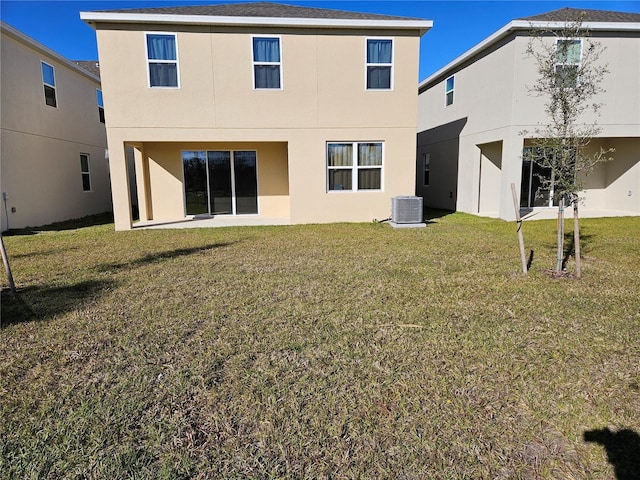 back of house with a lawn and central air condition unit