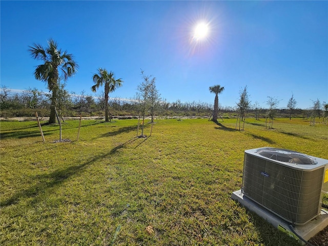 view of yard featuring central air condition unit and a rural view