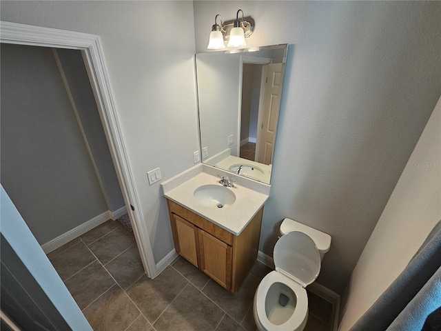 bathroom with vanity, tile patterned floors, and toilet