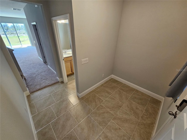 interior space with sink and light carpet