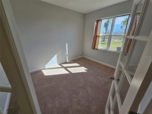 unfurnished room featuring carpet