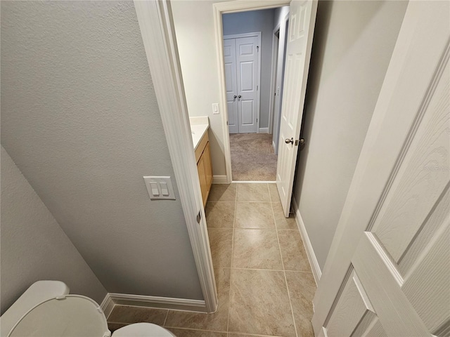 bathroom with vanity, toilet, and tile patterned flooring