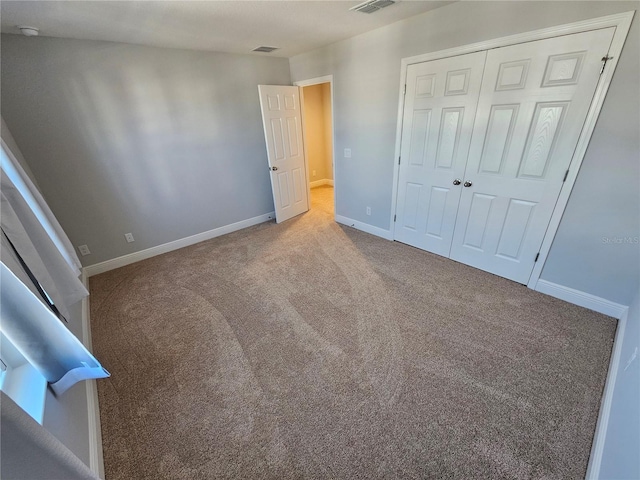 unfurnished bedroom featuring carpet and a closet