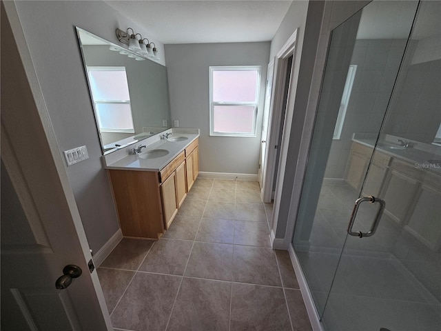 bathroom with vanity, a shower with shower door, and tile patterned floors