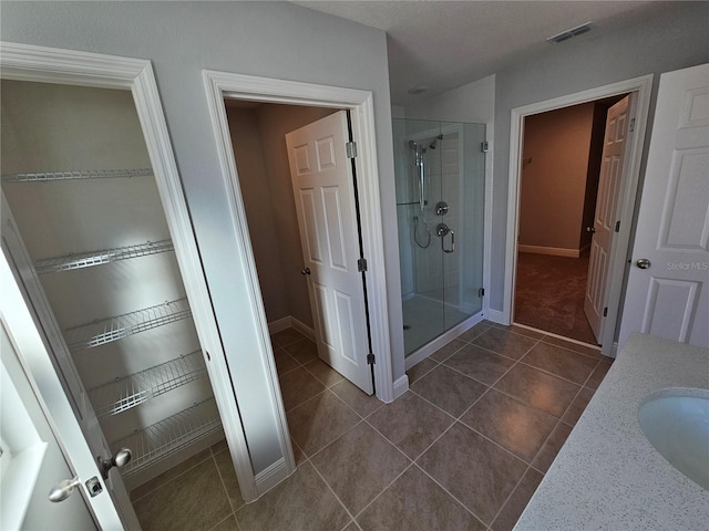 bathroom with vanity, tile patterned floors, and walk in shower