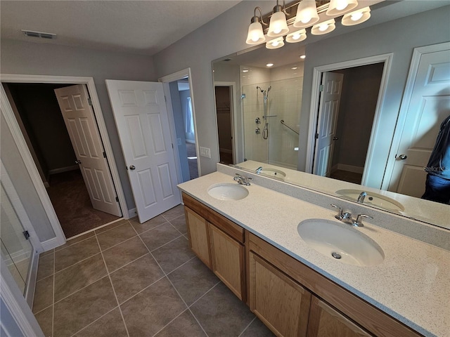 bathroom featuring vanity, tile patterned floors, and walk in shower