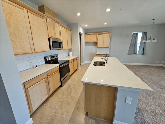 kitchen featuring sink, decorative backsplash, light brown cabinets, and appliances with stainless steel finishes