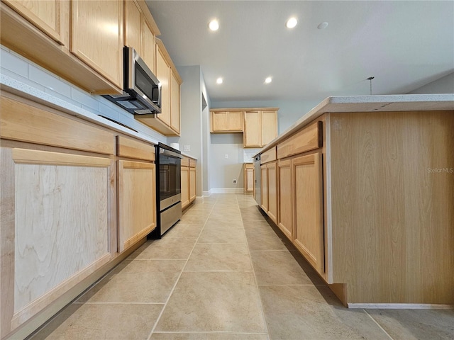 kitchen with stainless steel appliances and light brown cabinetry