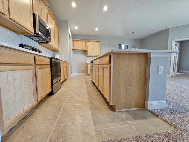 kitchen featuring decorative backsplash, appliances with stainless steel finishes, light brown cabinetry, and light carpet