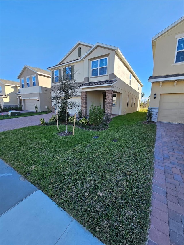 view of front of property featuring a garage and a front lawn