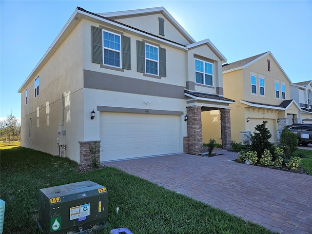 view of front of home featuring a garage and a front lawn