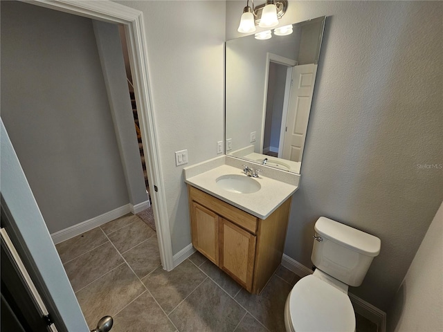 bathroom featuring vanity, toilet, and tile patterned flooring