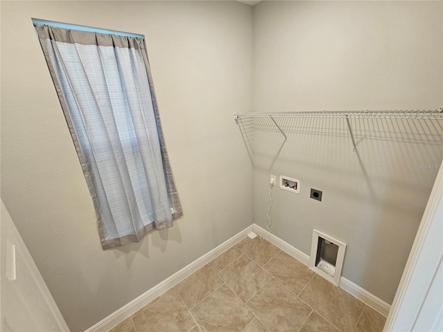 washroom featuring electric dryer hookup, washer hookup, and light tile patterned floors