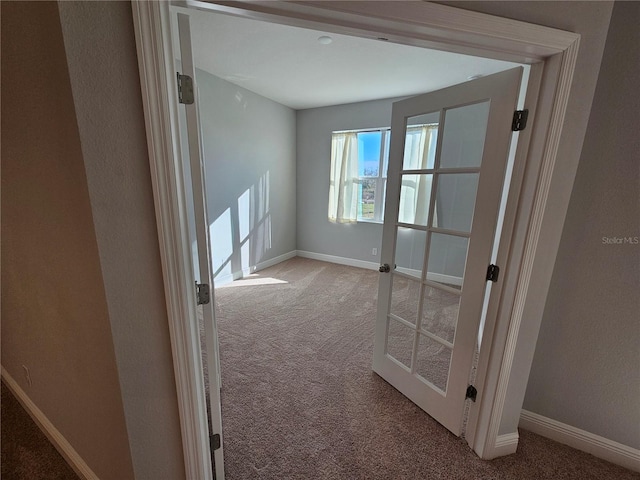 empty room with carpet and french doors