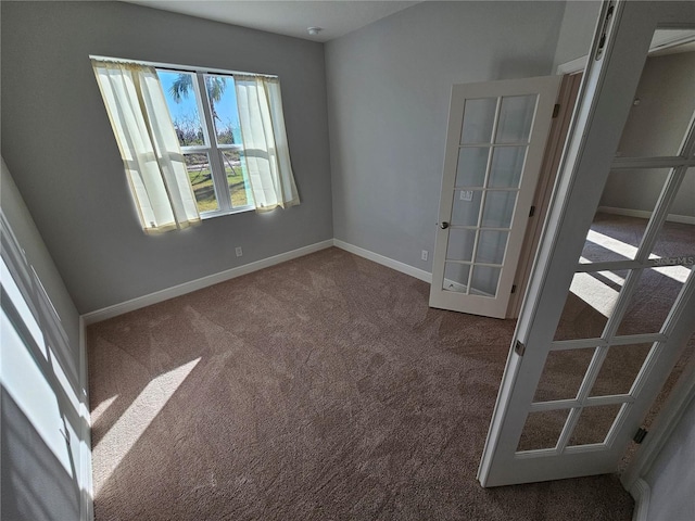 empty room with carpet and french doors