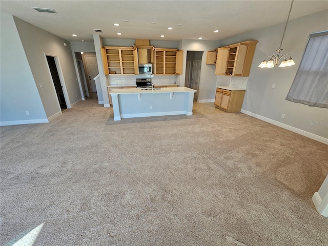 kitchen featuring stainless steel appliances, light carpet, backsplash, and decorative light fixtures