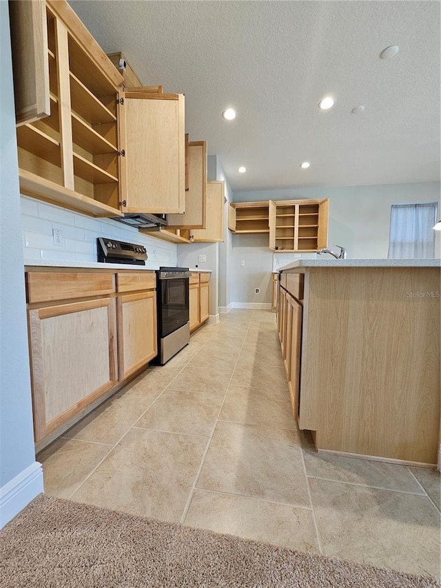 kitchen with decorative backsplash, stainless steel electric range oven, light brown cabinetry, and a textured ceiling