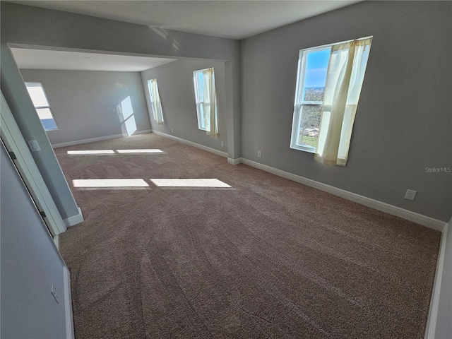 carpeted empty room featuring plenty of natural light