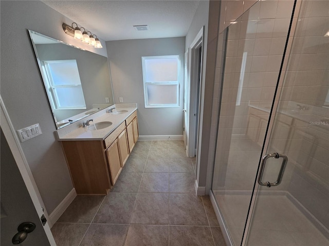 bathroom featuring an enclosed shower, vanity, and tile patterned flooring