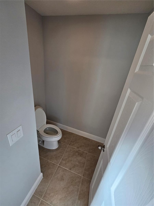 bathroom featuring tile patterned floors and toilet