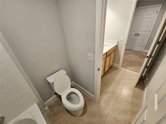 bathroom featuring tile patterned flooring, vanity, and toilet