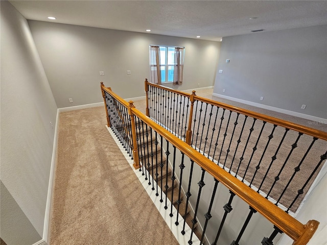 staircase with carpet floors