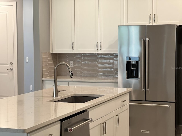 4535 Gliding Wave St, Winter Garden, FL 34787 - kitchen with sink, light stone counters, white cabinetry, appliances with stainless steel finishes, and backsplash
