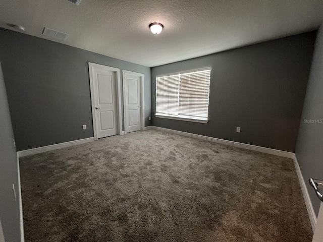4535 Gliding Wave St, Winter Garden, FL 34787 - unfurnished bedroom with a textured ceiling and carpet flooring