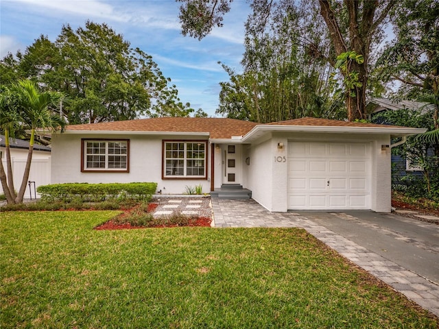 ranch-style house featuring a front yard and a garage