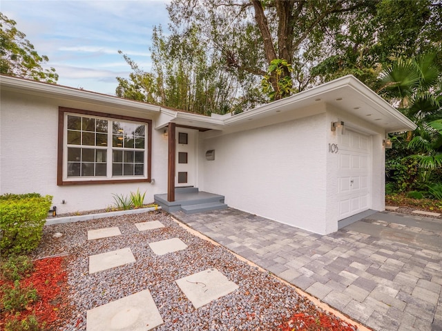 doorway to property with a garage