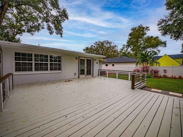 wooden terrace featuring a lawn