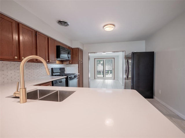 kitchen with stainless steel appliances, tasteful backsplash, and sink