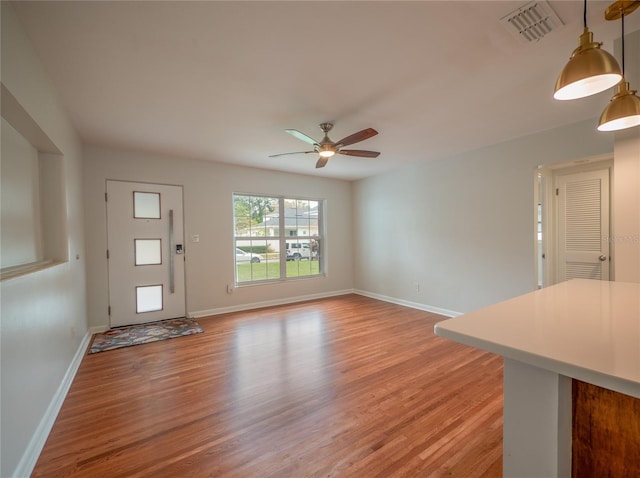 unfurnished living room with ceiling fan and light hardwood / wood-style floors