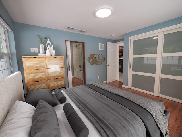 bedroom with hardwood / wood-style flooring